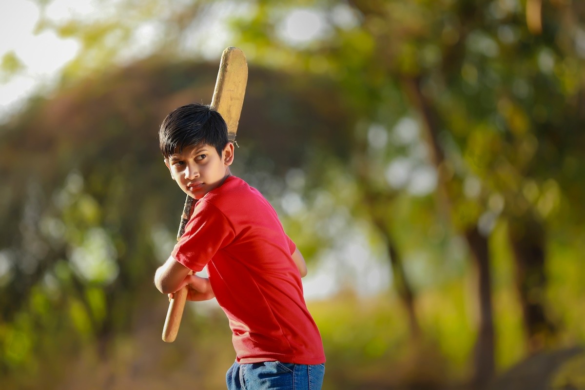 طفل هندي يلعب لعبة Gully Cricket
